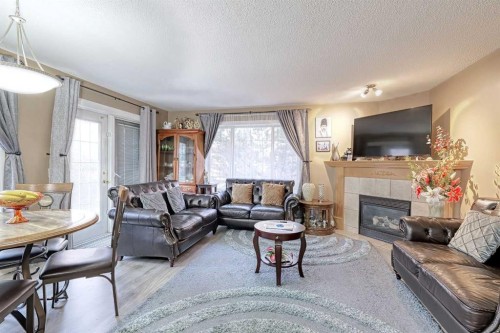501 Coral Cove Ne, Calgary, AB - Indoor Photo Showing Living Room With Fireplace
