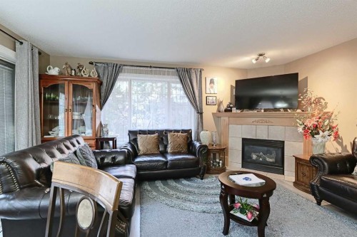 501 Coral Cove Ne, Calgary, AB - Indoor Photo Showing Living Room With Fireplace