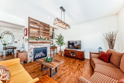44 Riviera Way, Cochrane, AB - Indoor Photo Showing Living Room With Fireplace