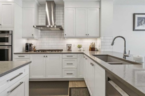 55 Sundown Crescent, Cochrane, AB - Indoor Photo Showing Kitchen With Double Sink With Upgraded Kitchen