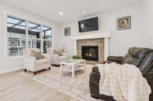 55 Sundown Crescent, Cochrane, AB - Indoor Photo Showing Living Room With Fireplace