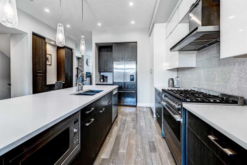 100 Burma Star Road Sw, Calgary, AB - Indoor Photo Showing Kitchen With Double Sink With Upgraded Kitchen