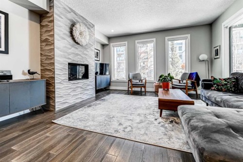 100 Burma Star Road Sw, Calgary, AB - Indoor Photo Showing Living Room With Fireplace