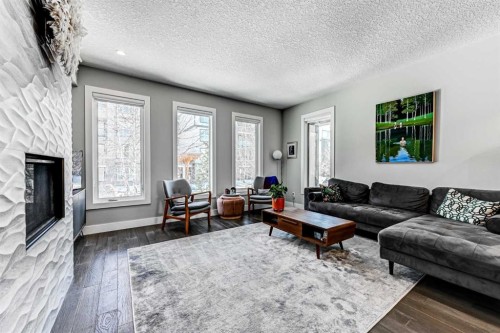 100 Burma Star Road Sw, Calgary, AB - Indoor Photo Showing Living Room With Fireplace