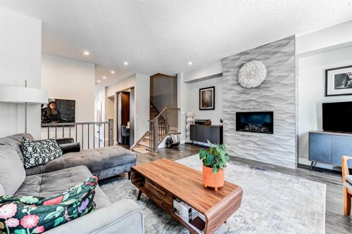 100 Burma Star Road Sw, Calgary, AB - Indoor Photo Showing Living Room With Fireplace