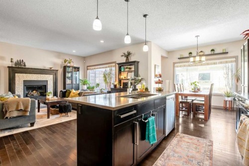 77 Elgin Meadows Manor Se, Calgary, AB - Indoor Photo Showing Kitchen With Fireplace With Double Sink