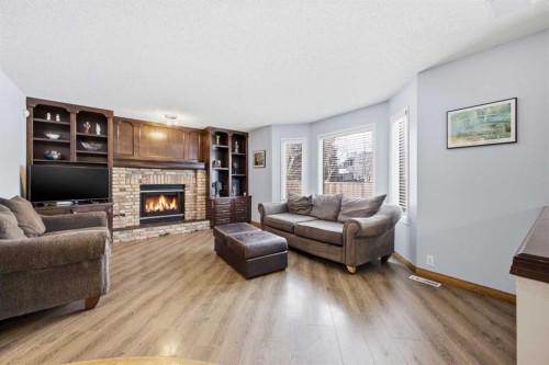 46 Sunset Way Se, Calgary, AB - Indoor Photo Showing Living Room With Fireplace