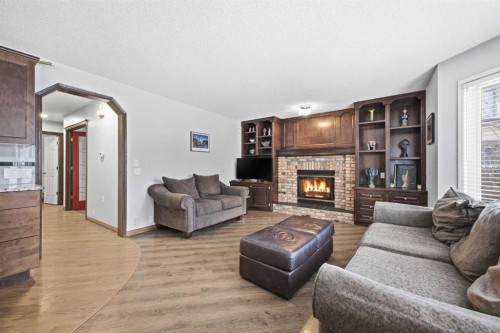 46 Sunset Way Se, Calgary, AB - Indoor Photo Showing Living Room With Fireplace