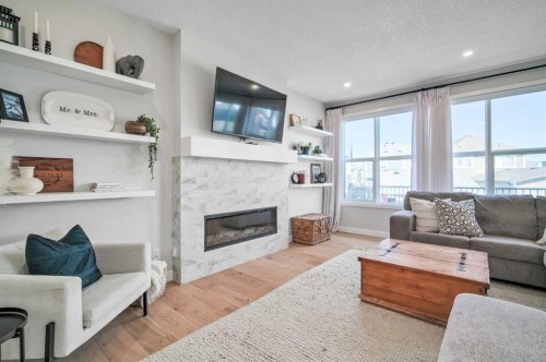 32 Magnolia Heath Se, Calgary, AB - Indoor Photo Showing Living Room With Fireplace