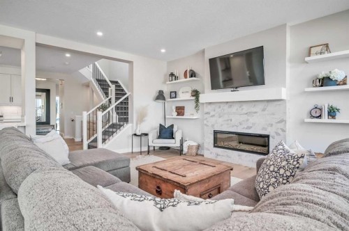 32 Magnolia Heath Se, Calgary, AB - Indoor Photo Showing Living Room With Fireplace