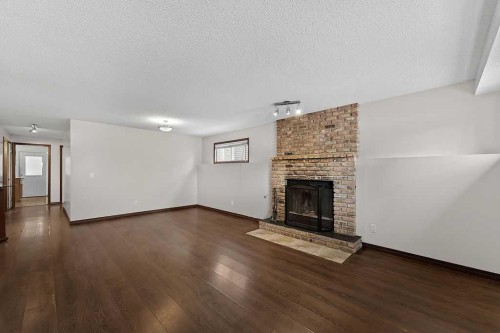 240 Riverbrook Way Se, Calgary, AB - Indoor Photo Showing Living Room With Fireplace