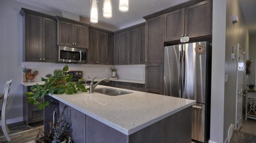 135 Reunion Loop Nw, Airdrie, AB - Indoor Photo Showing Kitchen With Double Sink