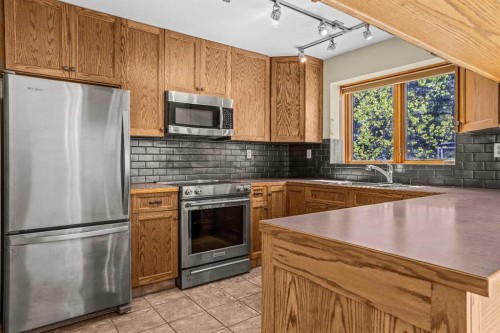 933 15Th Street, Canmore, AB - Indoor Photo Showing Kitchen With Double Sink