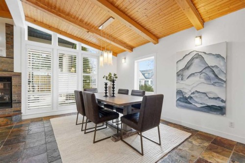 2623 Glenmount Drive Sw, Calgary, AB - Indoor Photo Showing Dining Room With Fireplace