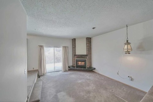616 Dalmeny Hill Nw, Calgary, AB - Indoor With Fireplace