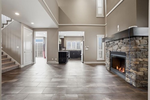 595 Panamount Boulevard Nw, Calgary, AB - Indoor Photo Showing Other Room With Fireplace