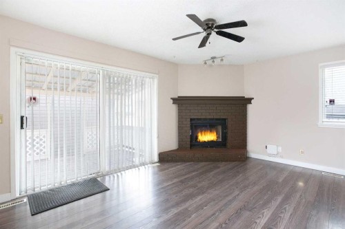 17 Martindale Drive Ne, Calgary, AB - Indoor Photo Showing Living Room With Fireplace