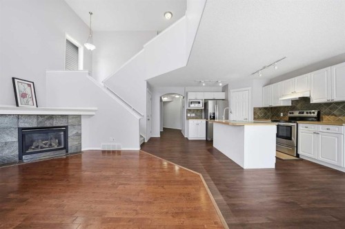 1076 Cranston Drive Se, Calgary, AB - Indoor Photo Showing Kitchen With Fireplace