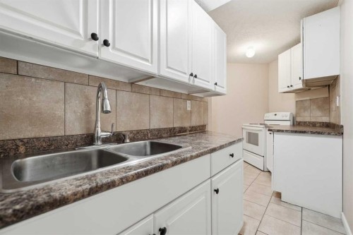 1076 Cranston Drive Se, Calgary, AB - Indoor Photo Showing Kitchen With Double Sink