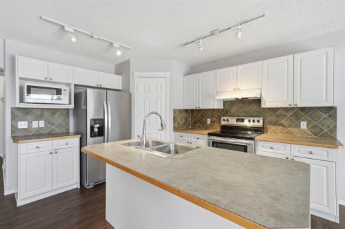 1076 Cranston Drive Se, Calgary, AB - Indoor Photo Showing Kitchen With Double Sink With Upgraded Kitchen