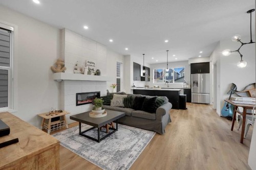 84 Magnolia Common Se, Calgary, AB - Indoor Photo Showing Living Room With Fireplace