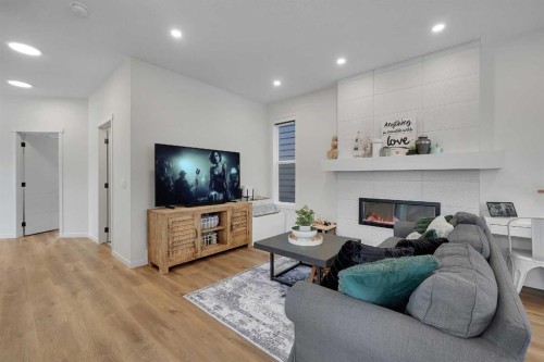 84 Magnolia Common Se, Calgary, AB - Indoor Photo Showing Living Room With Fireplace