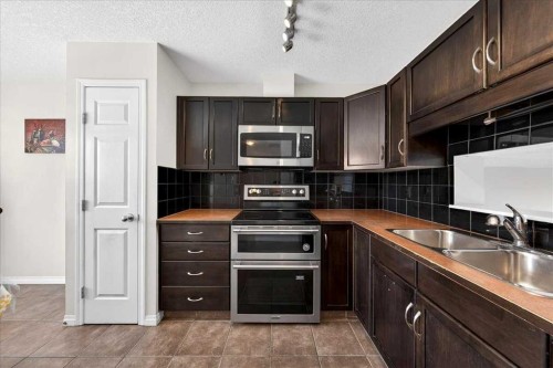 99 Copperfield Court Se, Calgary, AB - Indoor Photo Showing Kitchen With Double Sink