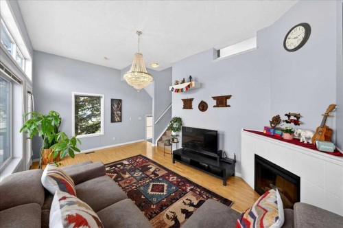 99 Copperfield Court Se, Calgary, AB - Indoor Photo Showing Living Room With Fireplace