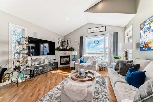 33 Boulder Creek Manor Se, Langdon, AB - Indoor Photo Showing Living Room With Fireplace