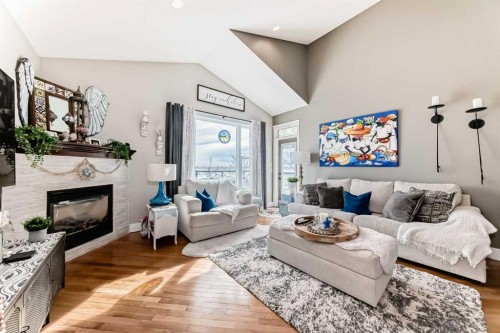 33 Boulder Creek Manor Se, Langdon, AB - Indoor Photo Showing Living Room With Fireplace