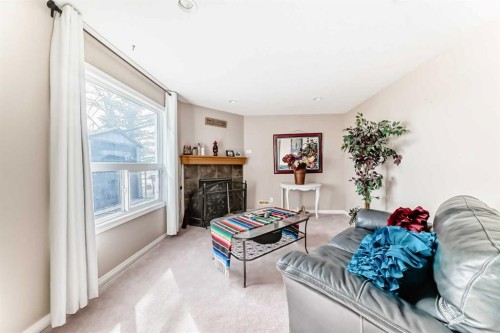 33 Boulder Creek Manor Se, Langdon, AB - Indoor Photo Showing Living Room With Fireplace