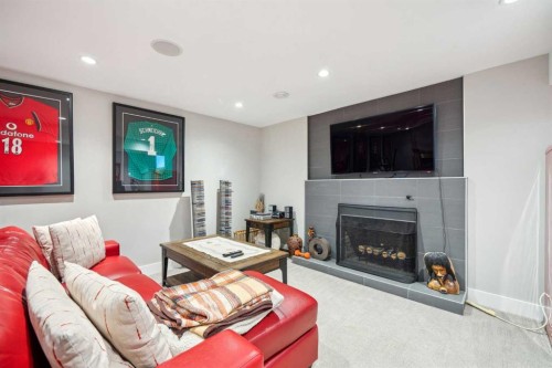 16 Meadowlark Crescent Sw, Calgary, AB - Indoor Photo Showing Living Room With Fireplace