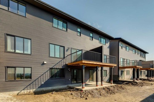 44 Heritage Manor, Cochrane, AB - Outdoor With Deck Patio Veranda With Exterior
