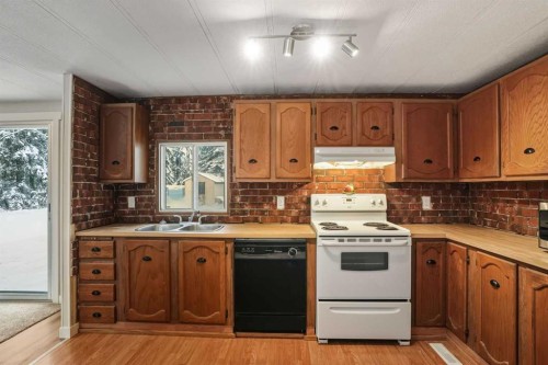 8 29415  Range Rd 52, Rural Mountain View County, AB - Indoor Photo Showing Kitchen With Double Sink