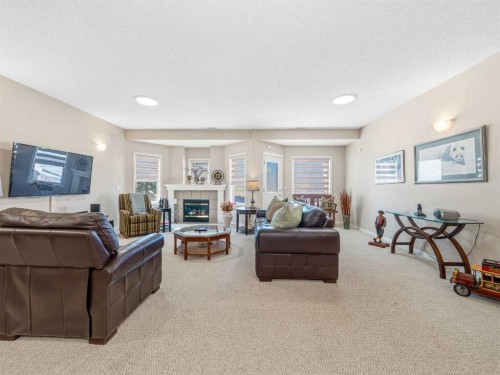 84 Sierra Morena Landing Sw, Calgary, AB - Indoor Photo Showing Other Room With Fireplace