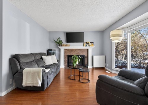 8005 Ranchview Drive Nw, Calgary, AB - Indoor Photo Showing Living Room With Fireplace