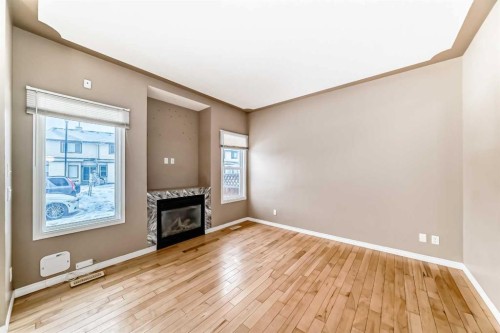 207-620 Luxstone Landing Sw, Airdrie, AB - Indoor With Fireplace