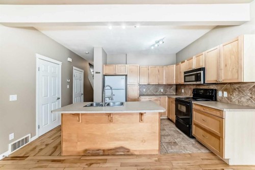 207-620 Luxstone Landing Sw, Airdrie, AB - Indoor Photo Showing Kitchen With Double Sink