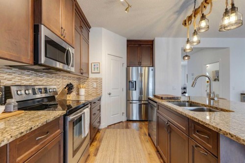 112 Fireside Drive, Cochrane, AB - Indoor Photo Showing Kitchen With Double Sink With Upgraded Kitchen