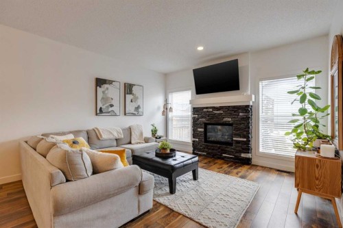 112 Fireside Drive, Cochrane, AB - Indoor Photo Showing Living Room With Fireplace