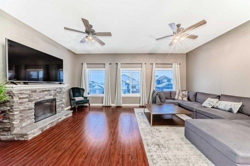 449 Sunset Link, Crossfield, AB - Indoor Photo Showing Living Room With Fireplace
