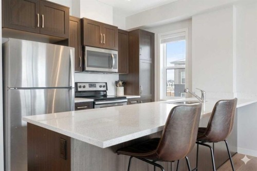 408-250 Fireside View, Cochrane, AB - Indoor Photo Showing Kitchen With Upgraded Kitchen