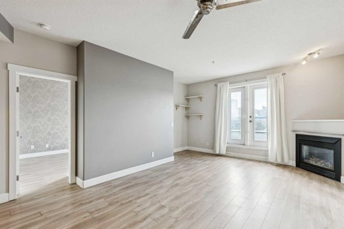 403-830 Centre Avenue Ne, Calgary, AB - Indoor Photo Showing Other Room With Fireplace