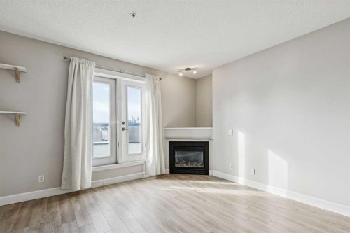 403-830 Centre Avenue Ne, Calgary, AB - Indoor Photo Showing Living Room With Fireplace