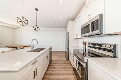 2307-55 Lucas Way Nw, Calgary, AB - Indoor Photo Showing Kitchen With Double Sink With Upgraded Kitchen