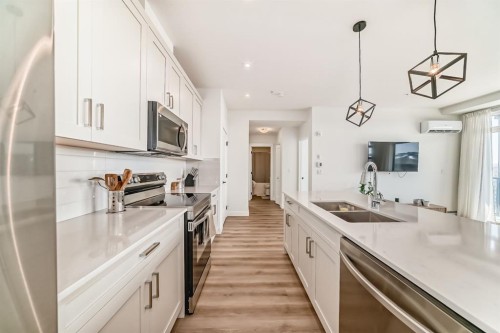 2307-55 Lucas Way Nw, Calgary, AB - Indoor Photo Showing Kitchen With Stainless Steel Kitchen With Double Sink With Upgraded Kitchen