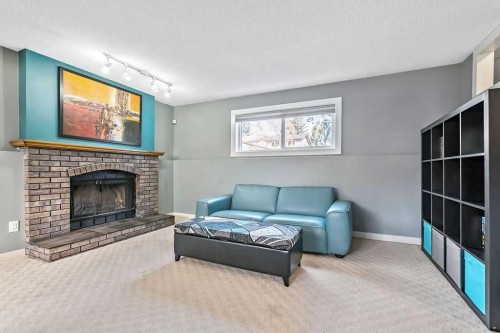 851 Mckenzie Drive Se, Calgary, AB - Indoor Photo Showing Living Room With Fireplace