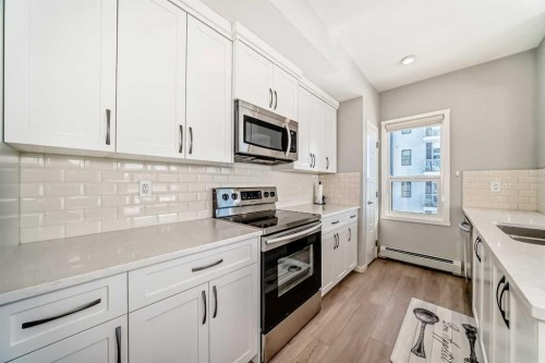 209-4250 Seton Drive Se, Calgary, AB - Indoor Photo Showing Kitchen With Double Sink With Upgraded Kitchen
