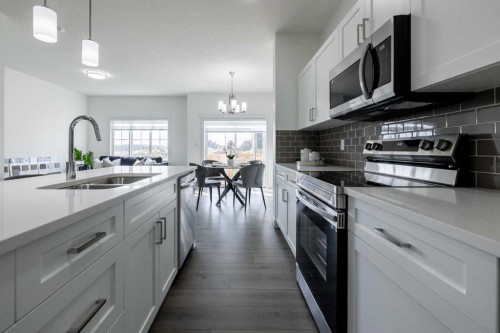 48 Heritage Manor, Cochrane, AB - Indoor Photo Showing Kitchen With Double Sink With Upgraded Kitchen