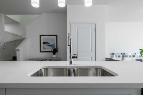 48 Heritage Manor, Cochrane, AB - Indoor Photo Showing Kitchen With Double Sink